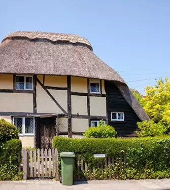 english cottage with hedge in garden